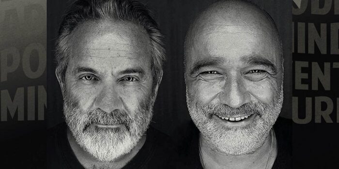 Black and white image of two older men with beards, just showing their faces