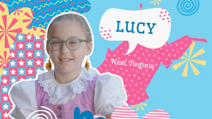 A young blond girl with glasses wearing a traditional Swiss dress. She smiles. Behind her is a graphic featuring the shape of the West Virginia state. It's pink with polka dots. Above the state is a voice bubble with the name "Lucy" seen inside.