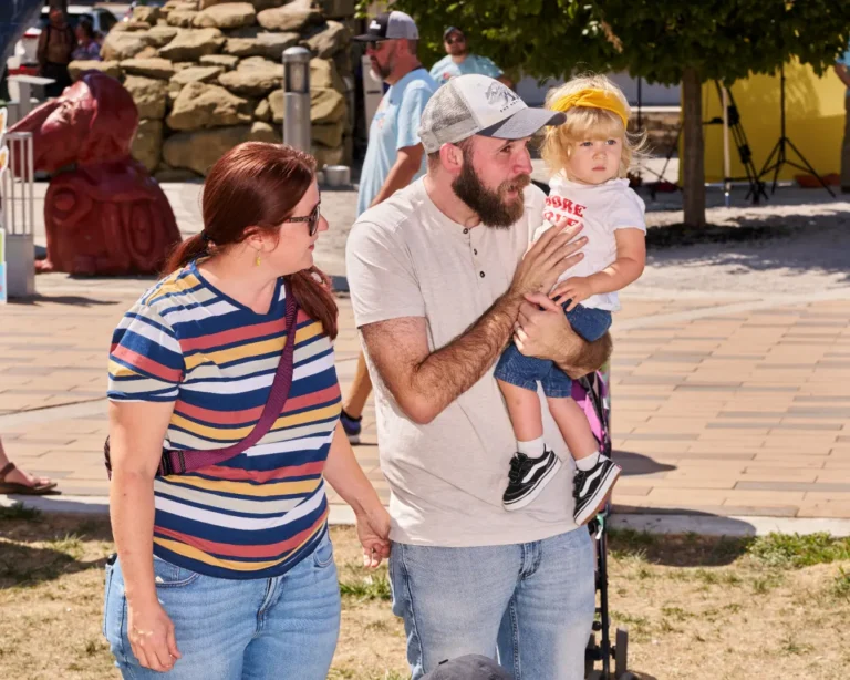 A family is visible together. A man, a woman, and a child.