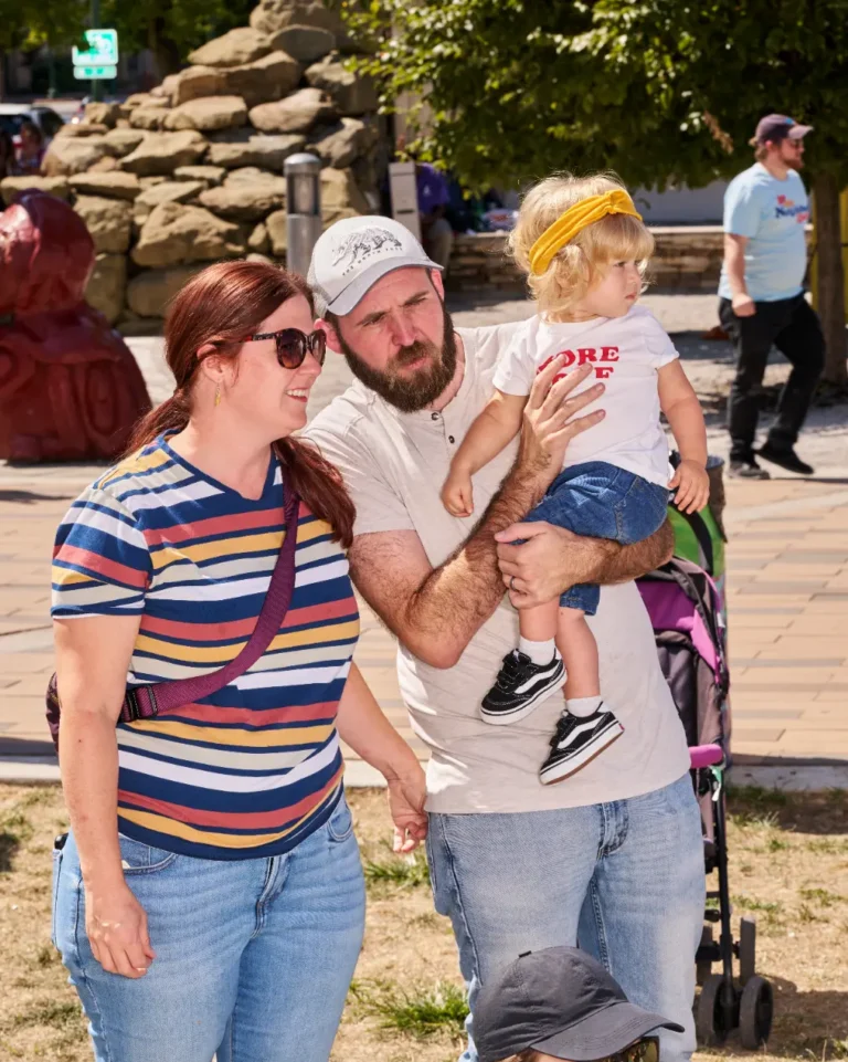 A family is visible together. A man, a woman, and a child.