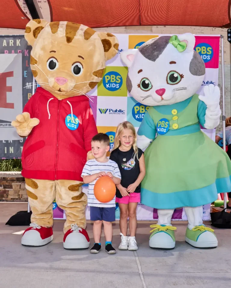 Daniel Tiger and Katerina Kittycat with two small children. A boy and a girl.