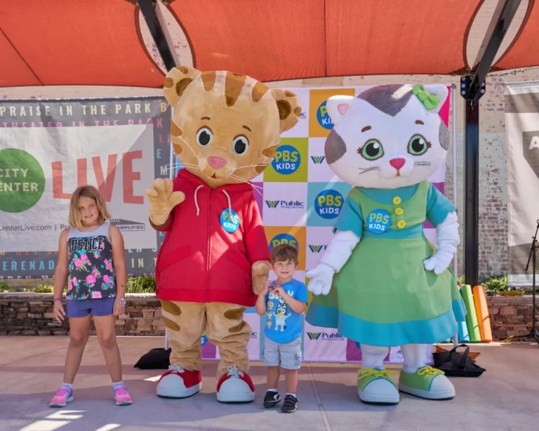 Daniel Tiger and Katerina Kittycat with two children, a girl and a little boy.