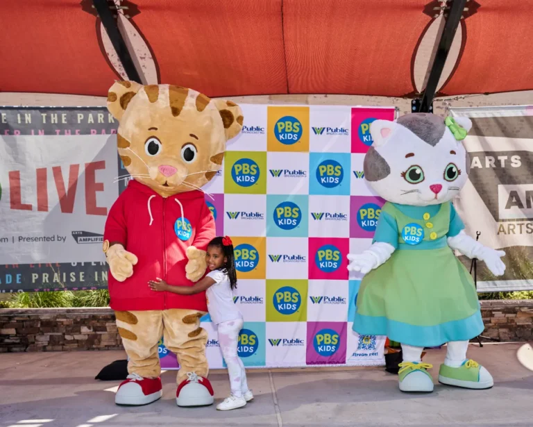 Daniel Tiger and Katerina Kittycat with a small girl.