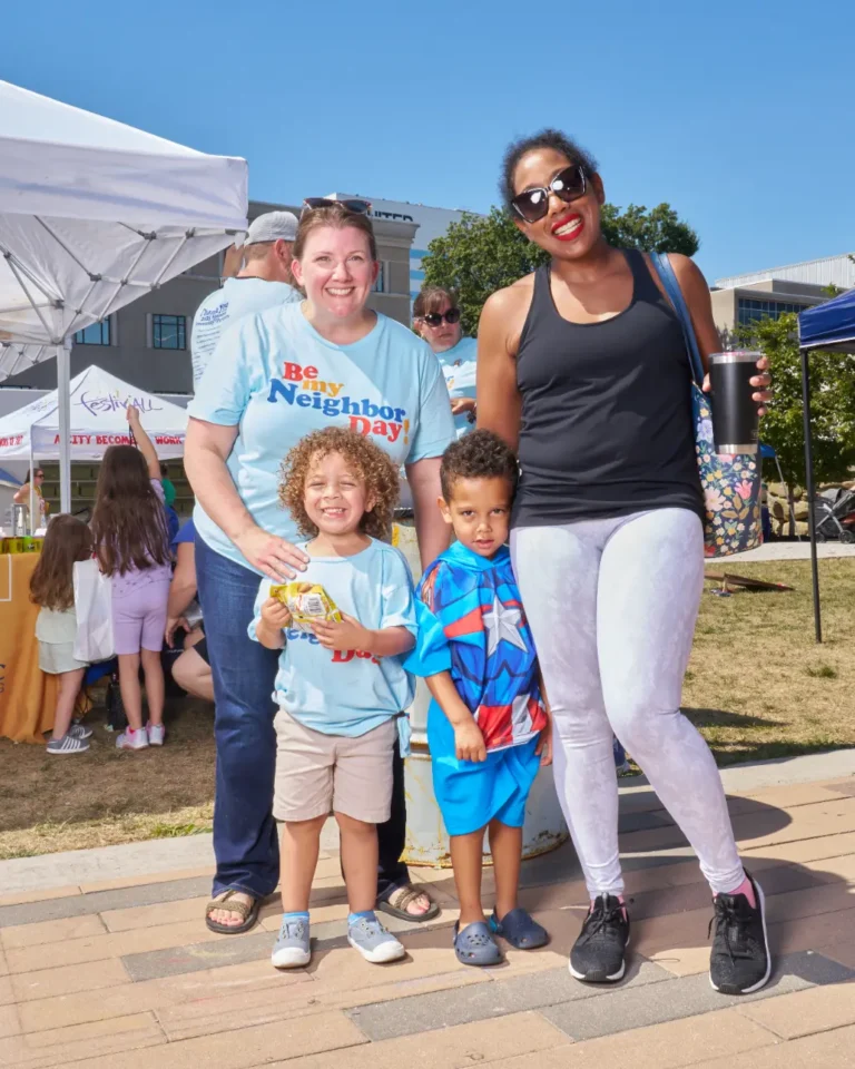 Two adults and two children pose for the camera, smiling.