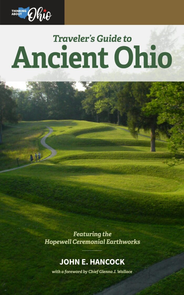 The cover of a book with the words "Traveler's Guide to Ancient Ohio" in the title. There is an imaged of a green serpent mound on the cover. The book was written by John E. Hancock and a foreword by Glenna J. Wallace.