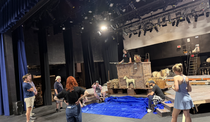 Seven play cast members on set discussing their parts