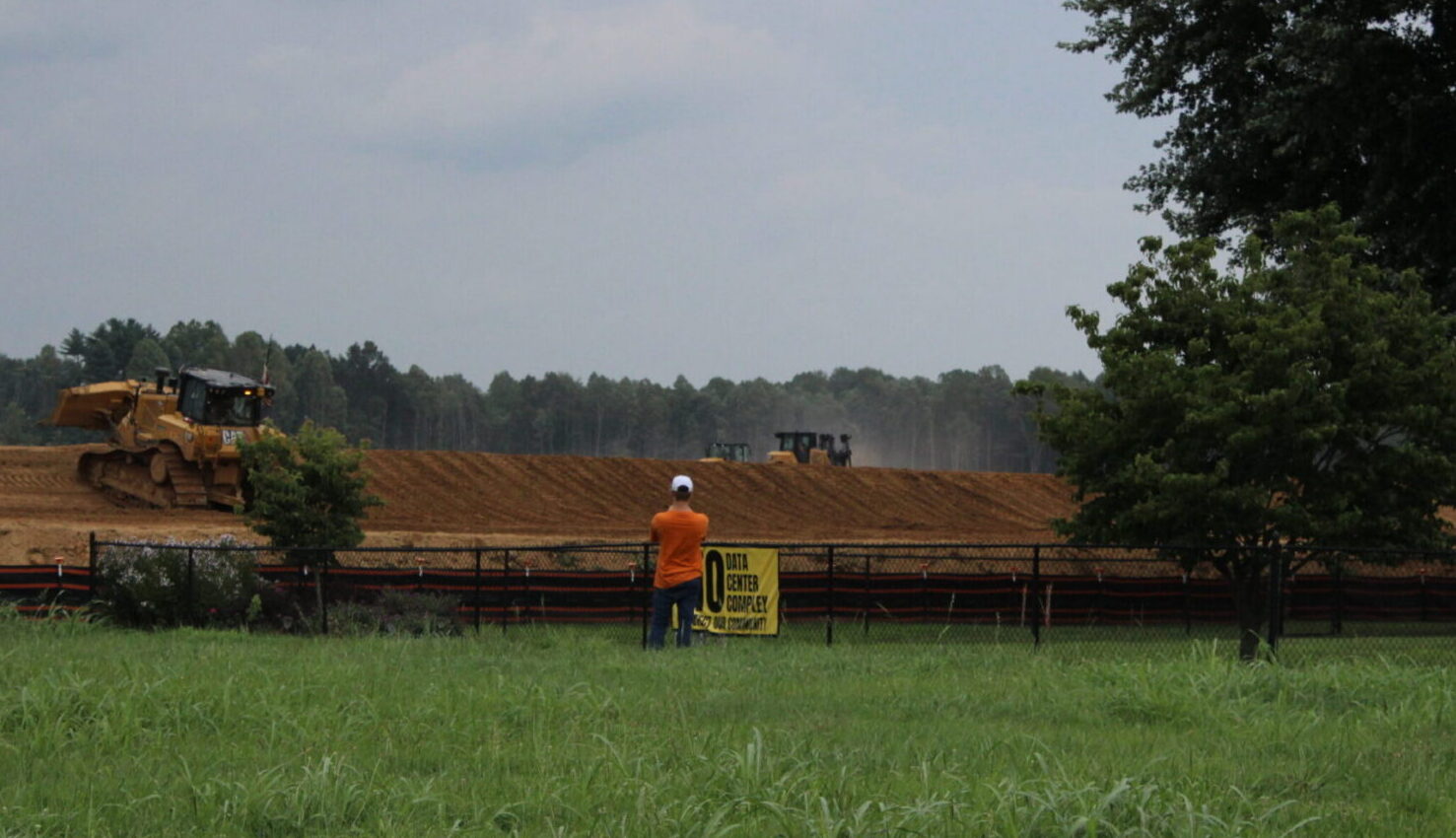 https://wvpublic.org/wp-content/uploads/2026/07/072126-Mason-County-Monarch-Compute-Campus-Development-Orange-Shirt-Chris-Schulz-West-Virginia-Public-Broadcasting-scaled-e1785759376914.jpg