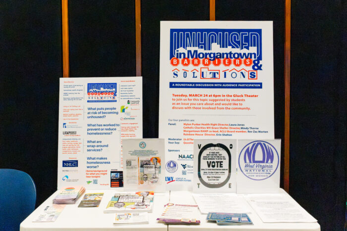 Two posters on display on a table.