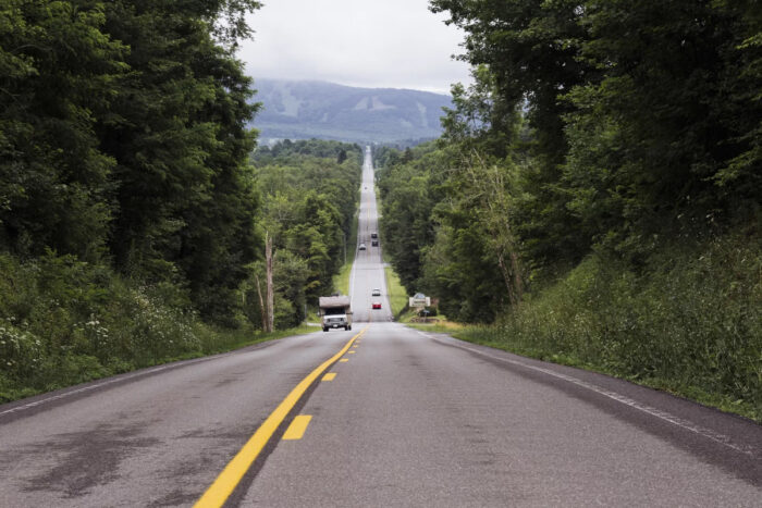 Straight country road with mountains in the distance