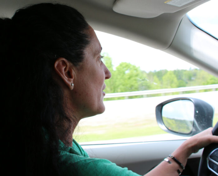 woman in profile driving a car