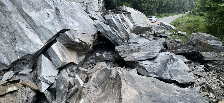 Massive boulders cover a road