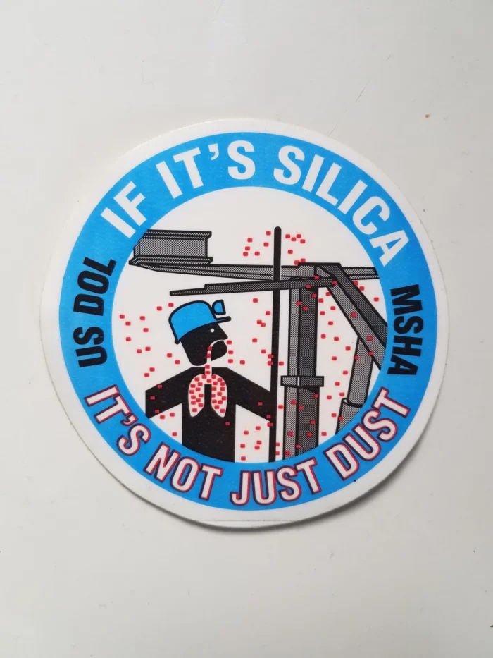 A close up of a sticker featuring an illustration of a miner breathing in silica dust.