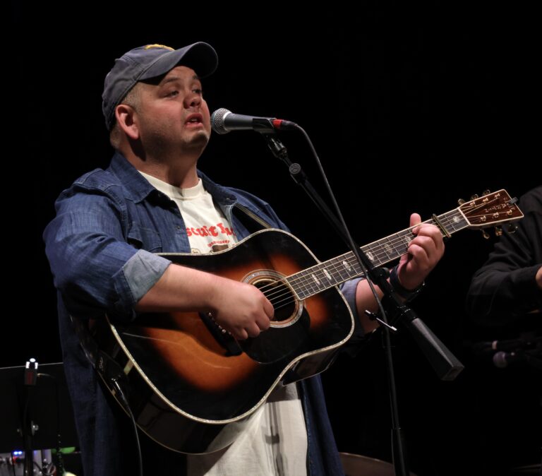 man plays guitar