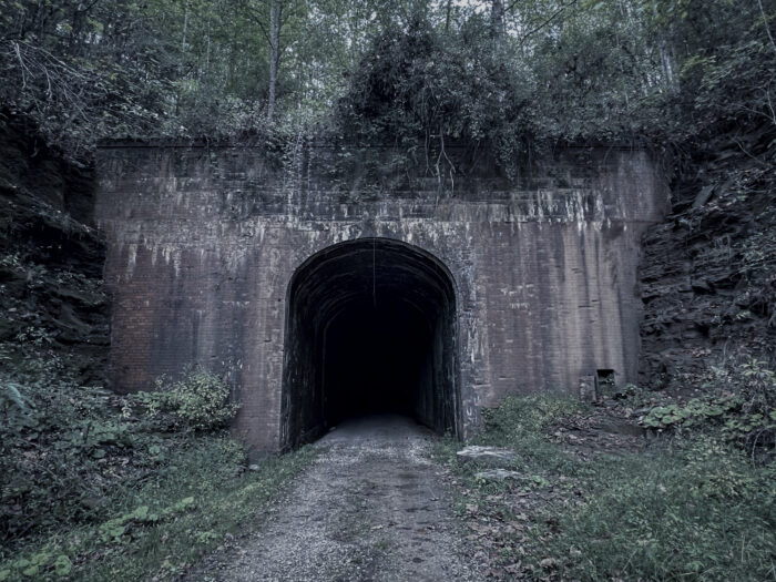dark tunnel opening in rock