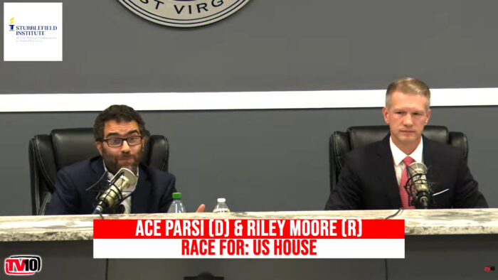 Two men sit at a desk
